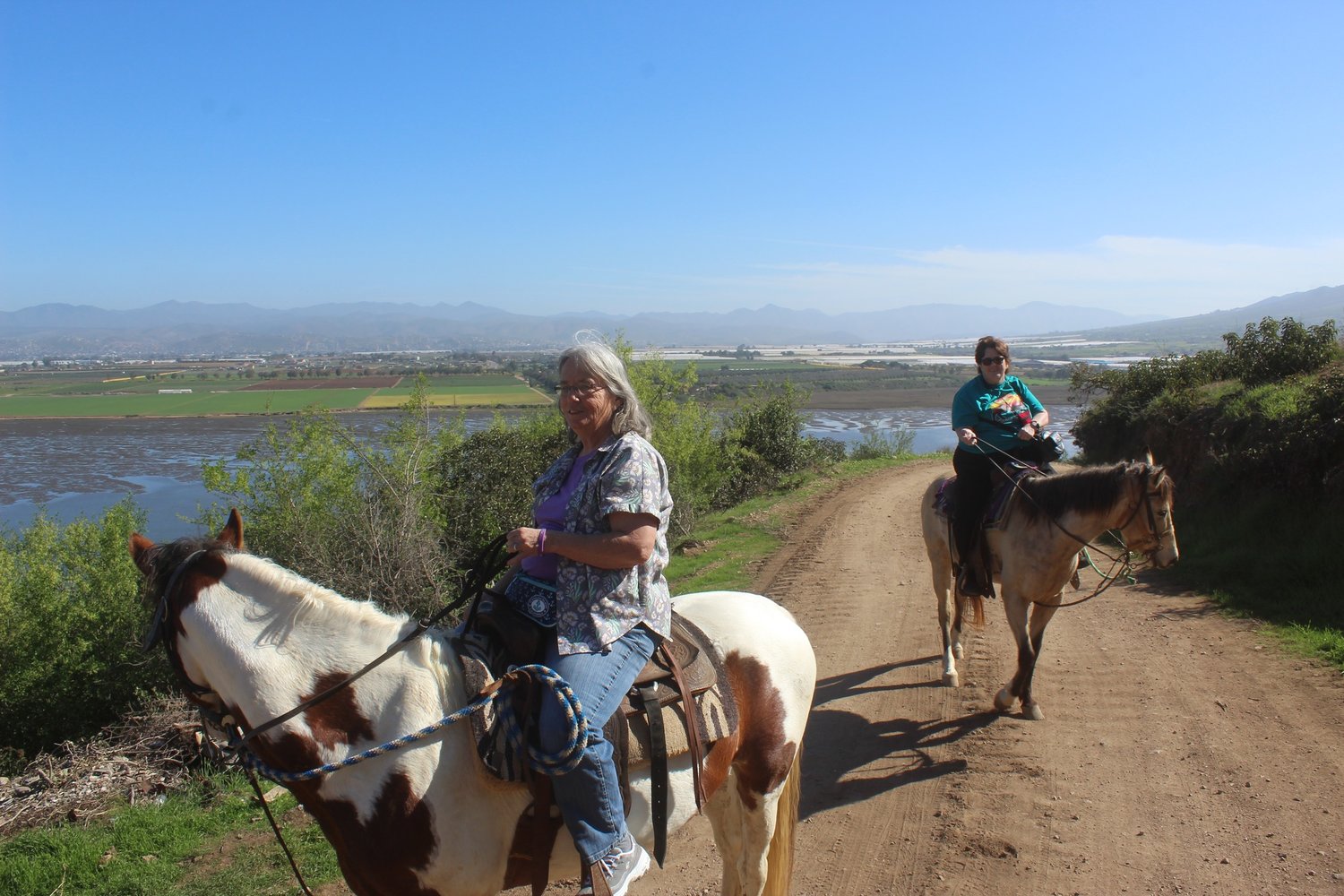 Columnist Julie McDonald, right, rides a horse in Ensenada.